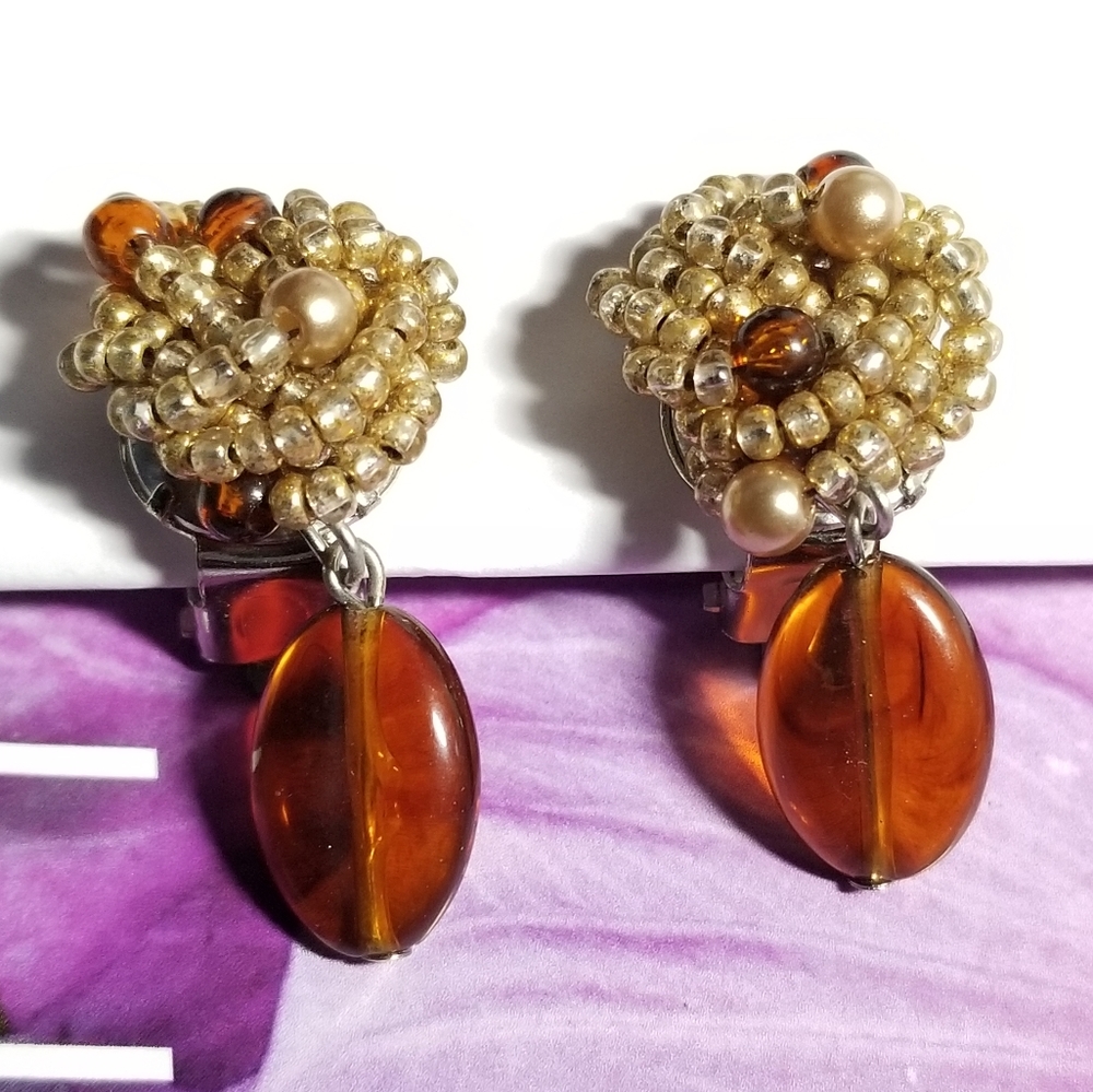 Vintage beaded clip earrings with amber orange brown color dangles